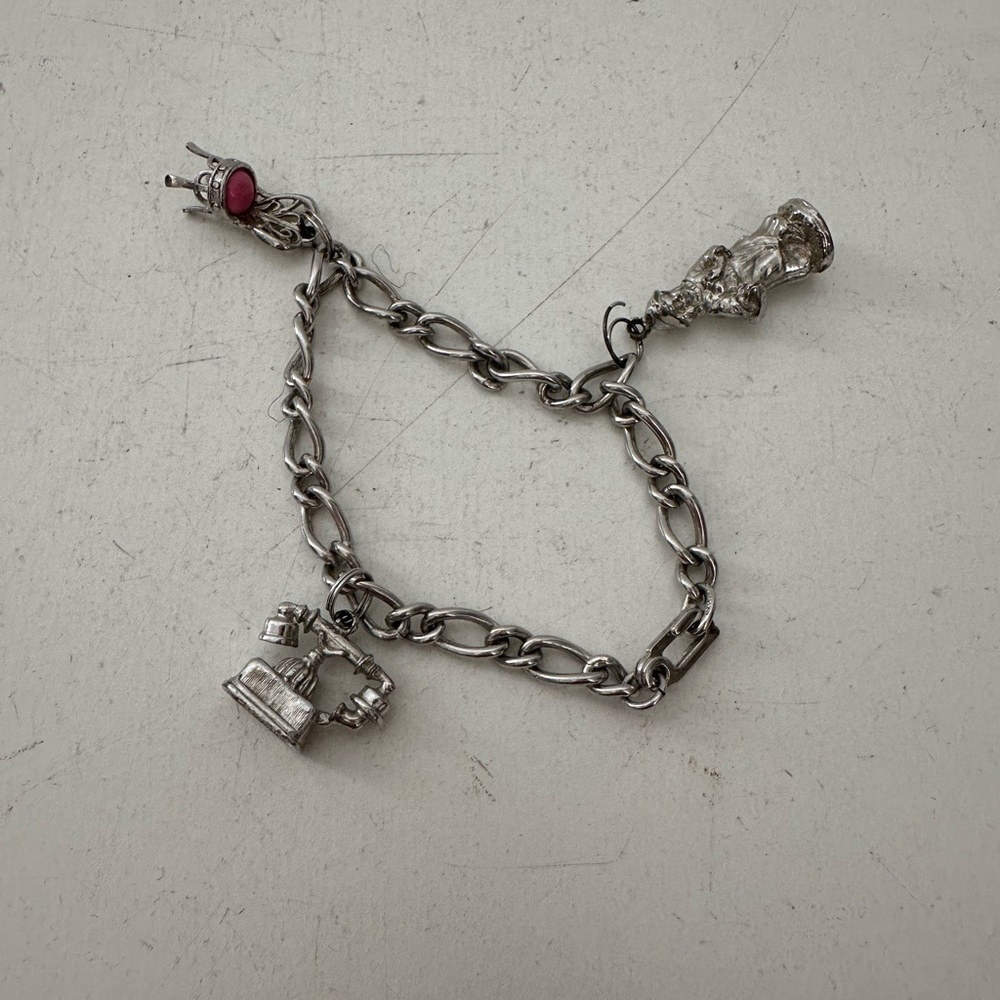 Vintage Avon charm bracelet with 3 charms telephone, pink chair and girl